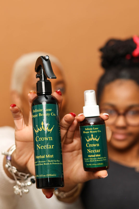 Two people holding bottles of 'Crown Nectar' Herbal Mist from Definitive Luxe Brown Beauty Co.